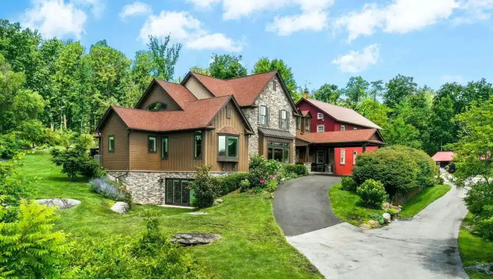 Generational compound with paved driveway surrounded by trees.