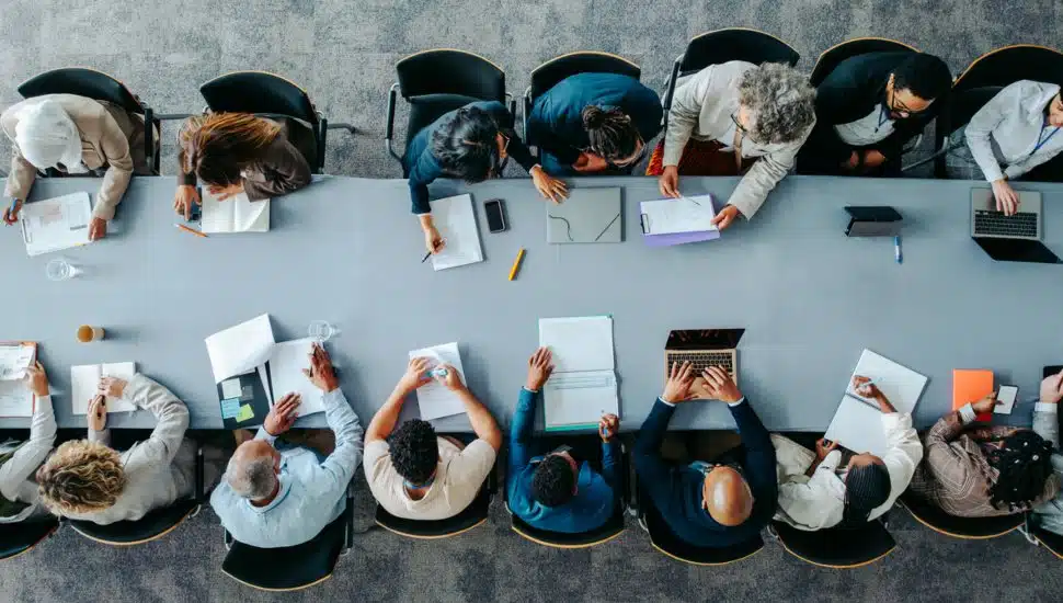 Top down view of people working at a table.