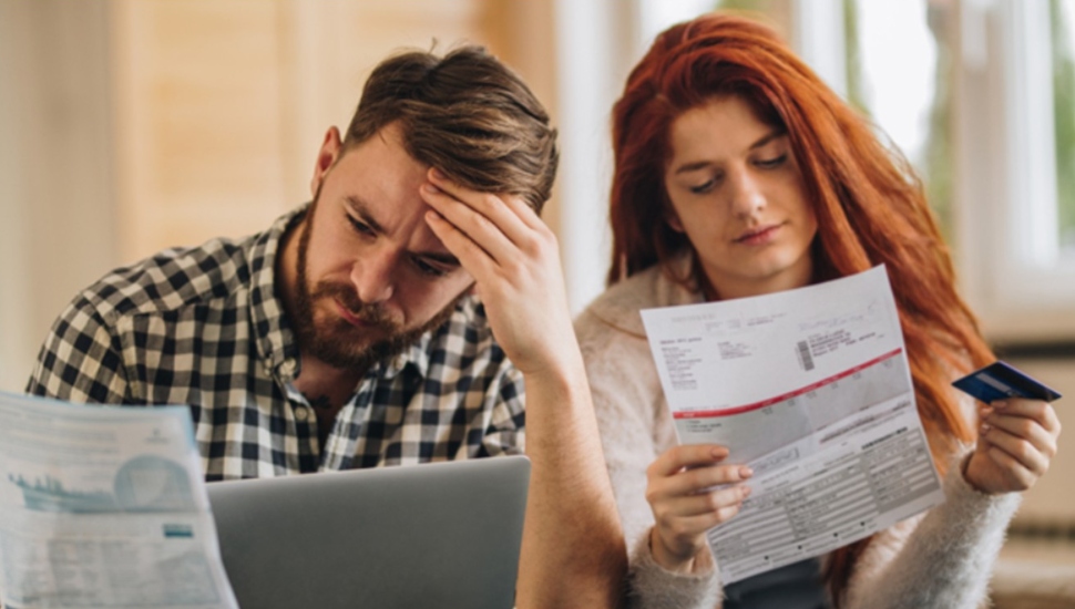 Man and woman look over their credit scores.