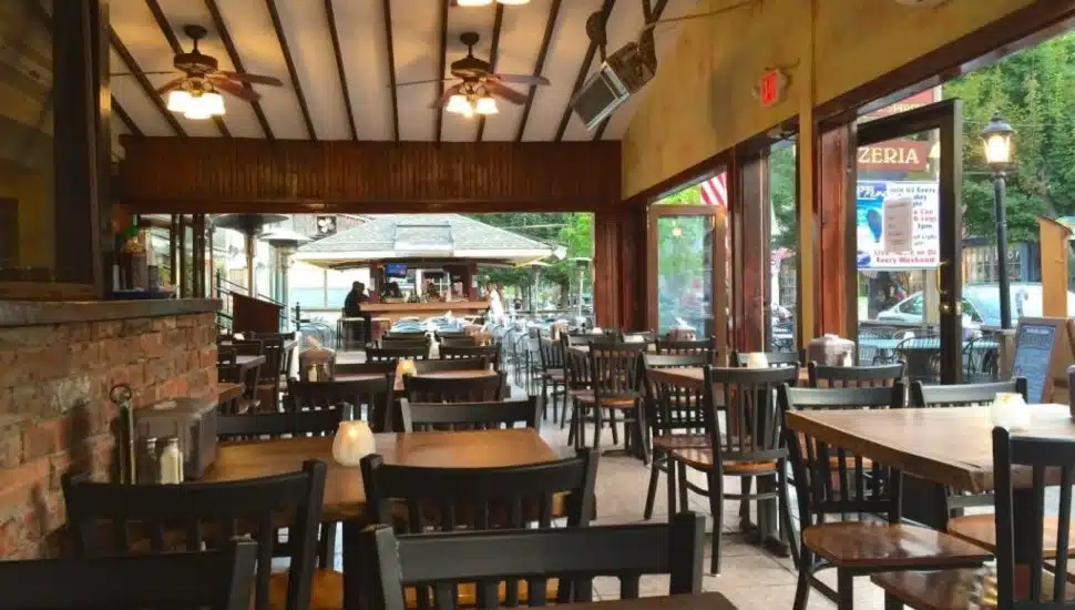 Seating at Fran’s Pub with wooden chairs and tables.