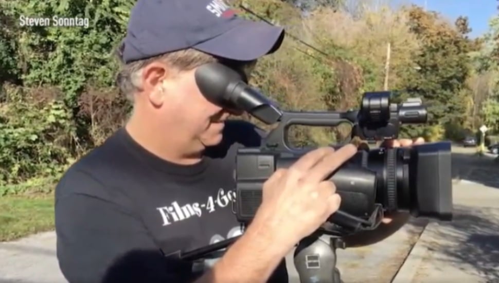 Gary Chilutti filming with camera.