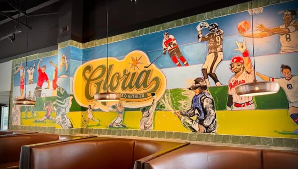 Wall art of Philadelphia athletes at Gloria Spots & Spirits.