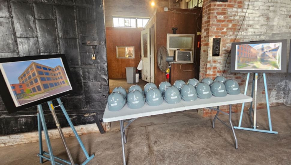 Hard hats and renderings for the new Dwight City Group apartments.