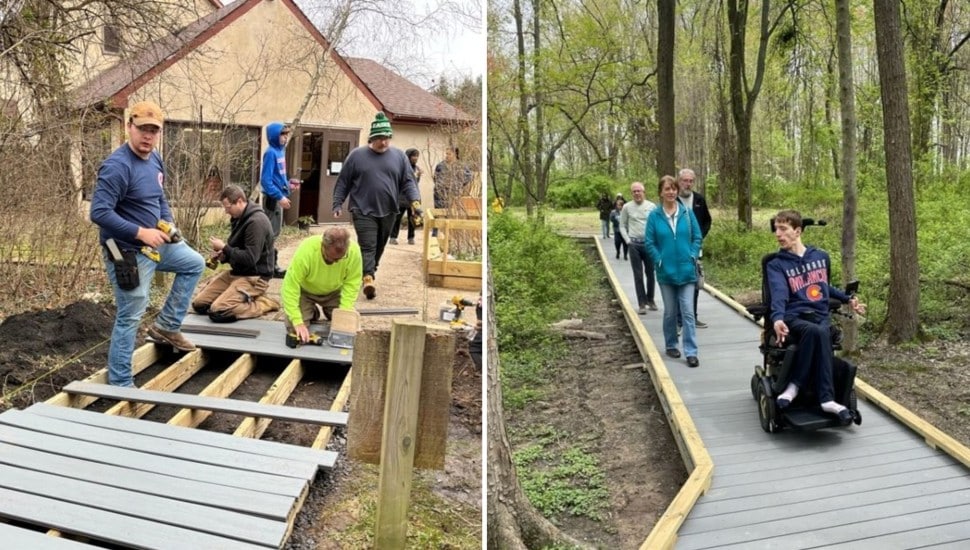Volunteers construct a boardwalk in the woods.
