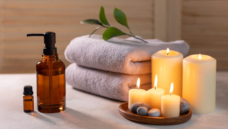 Beauty spa treatment items on white wooden table.