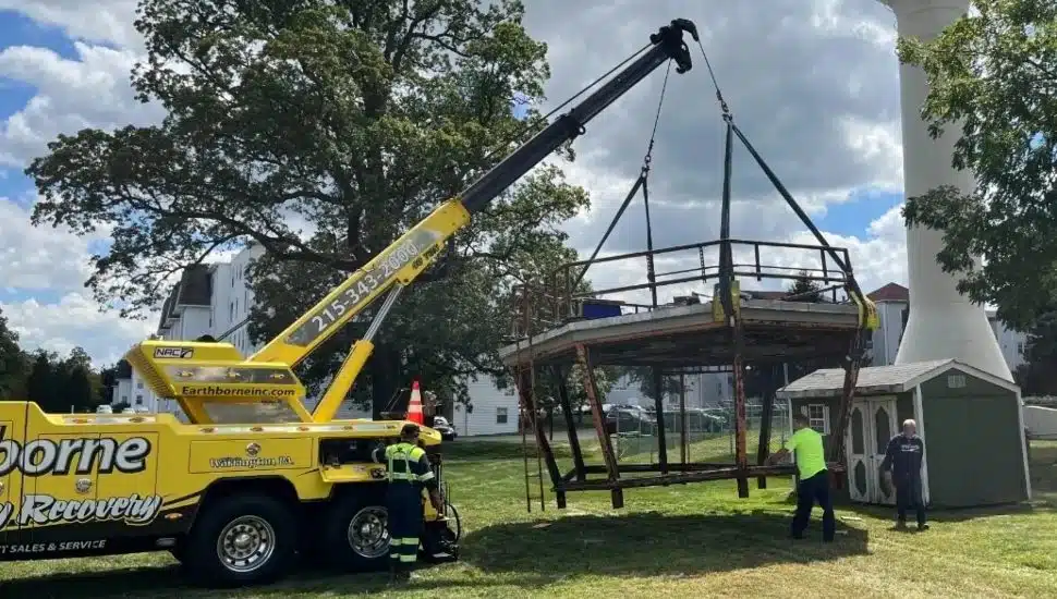 Top of Willow Grove air traffic control tower lifted by crane.