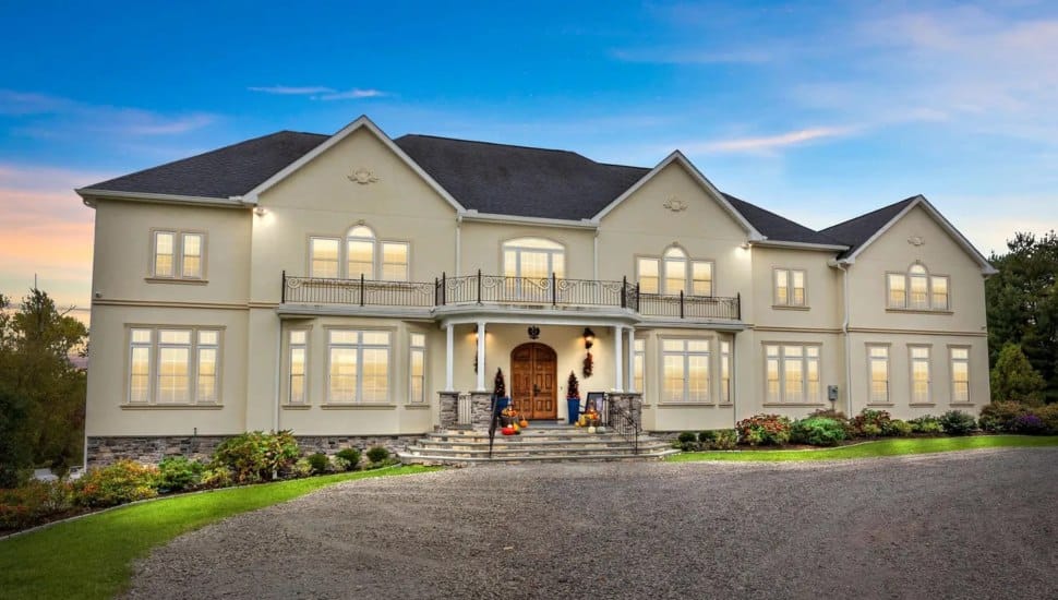 Large colonial-style mansion with driveway.
