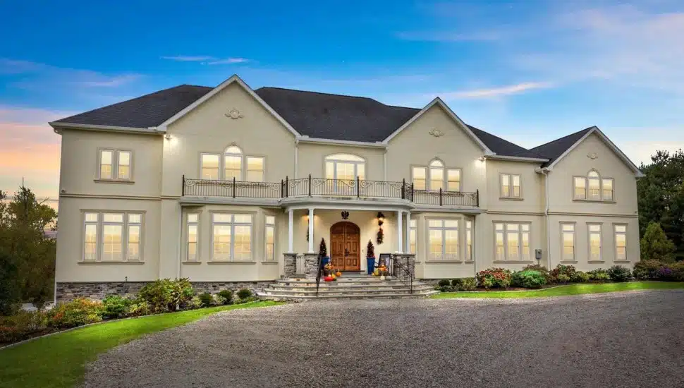 Large colonial-style mansion with driveway.