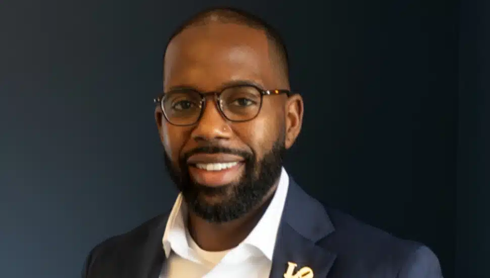 Middle-aged male banking executive with beard and glasses.