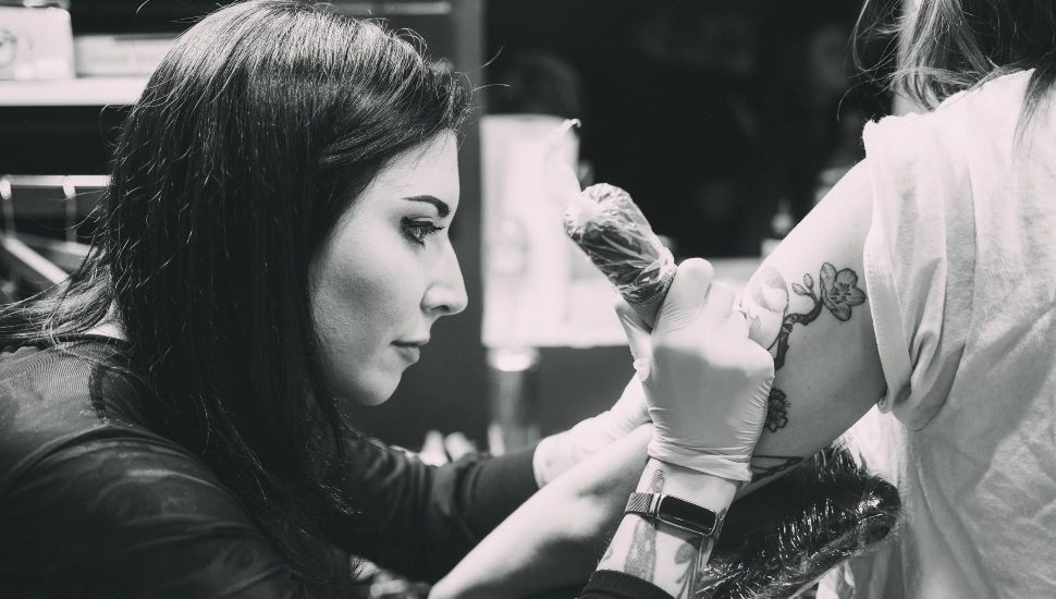 Megan Kovak Cohen doing a tattoo.