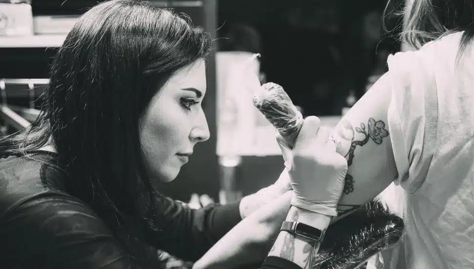 Megan Kovak Cohen doing a tattoo.