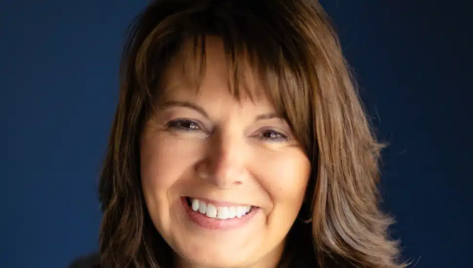 Headshot of female bank executive with dark hair.