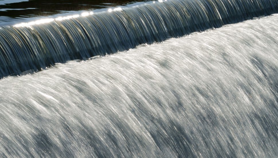 Beautiful flowing water over a cascading bridge forming stunning patterns and textures.