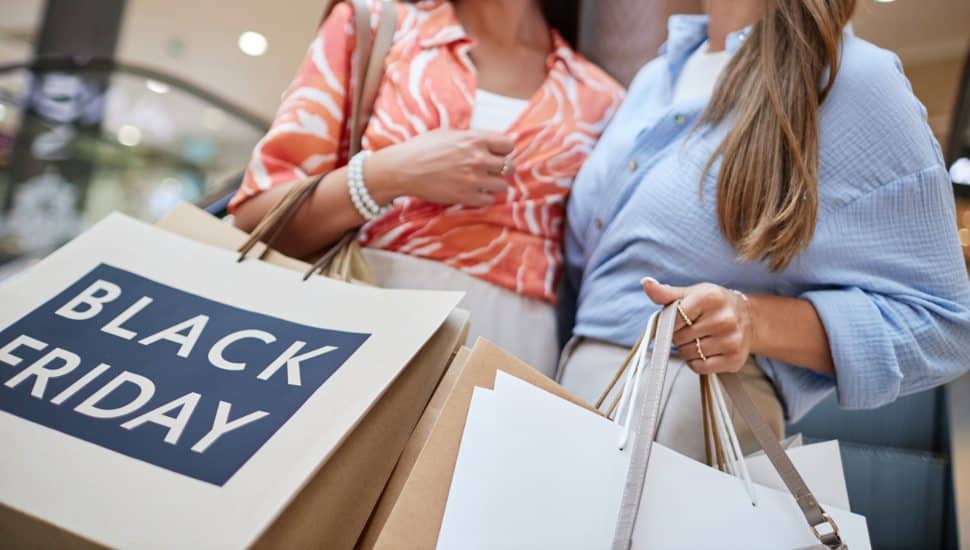 Black Friday shoppers with bags.