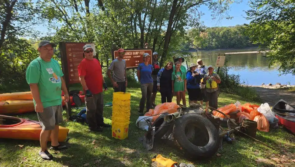 Volunteers with their collected trash on the river.