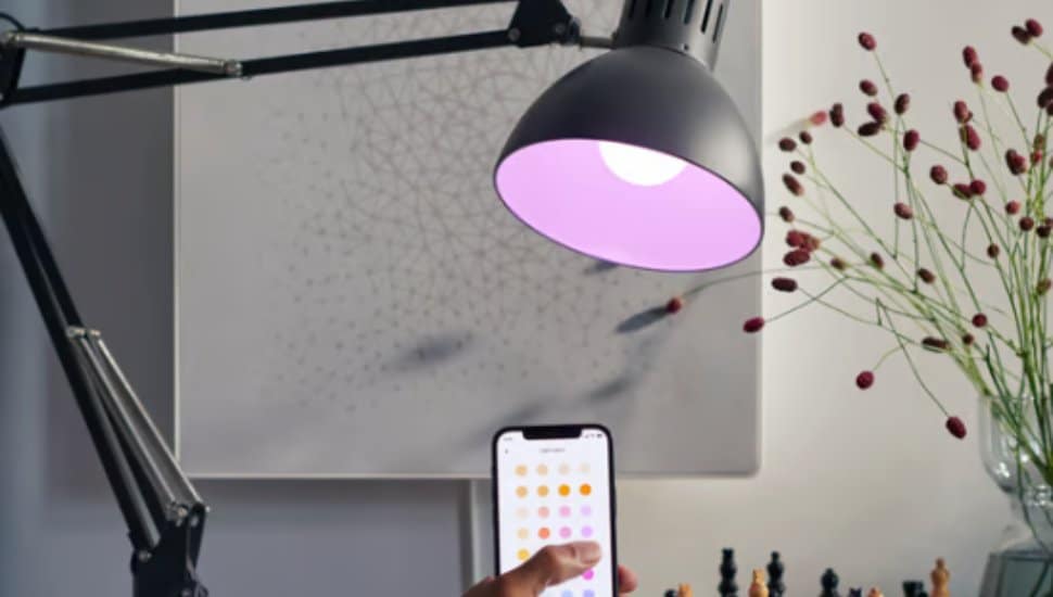 A smart phone controls a lamp.