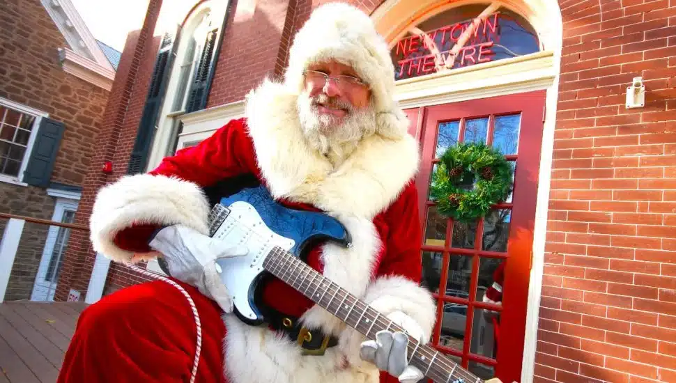 Santa playing guitar outside the Newtown Theatre.