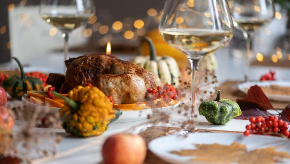 Traditional festive dinner with roasted turkey served on table.