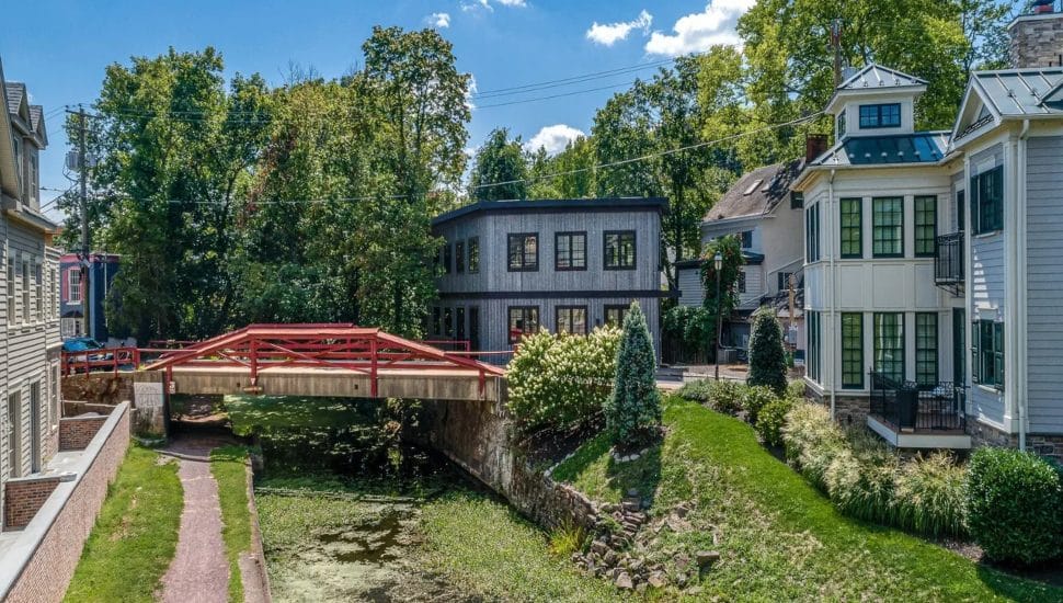 Modern home with a footbridge spanning the canal in New Hope.
