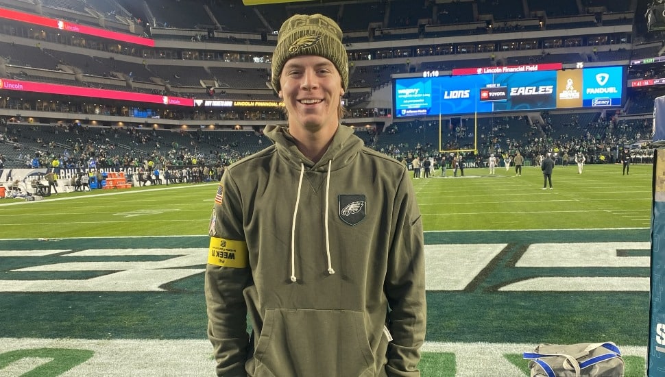 Man stands on field during NFL game.