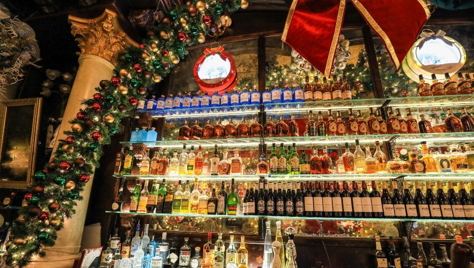 The interior of a bar decorated with festive holiday decorations.