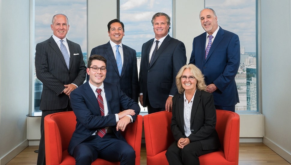 Five male and one female executives at Janney Montgomery Scott.