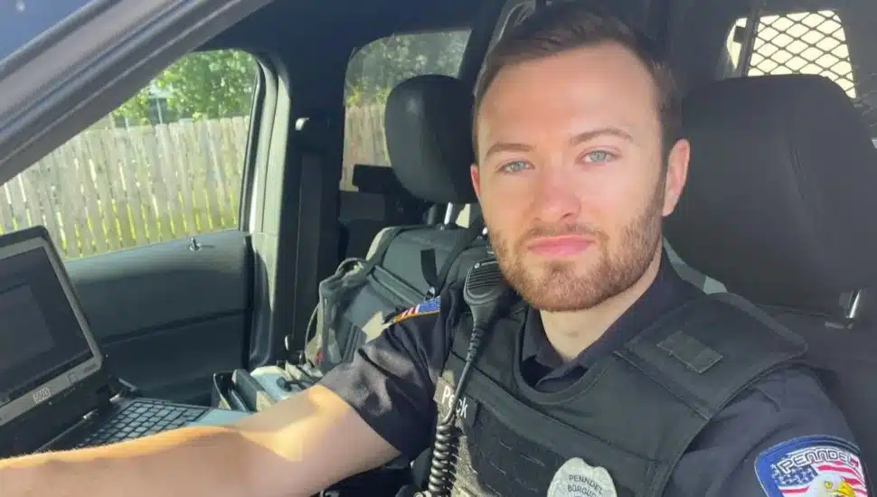 Sean Peck in his police car.