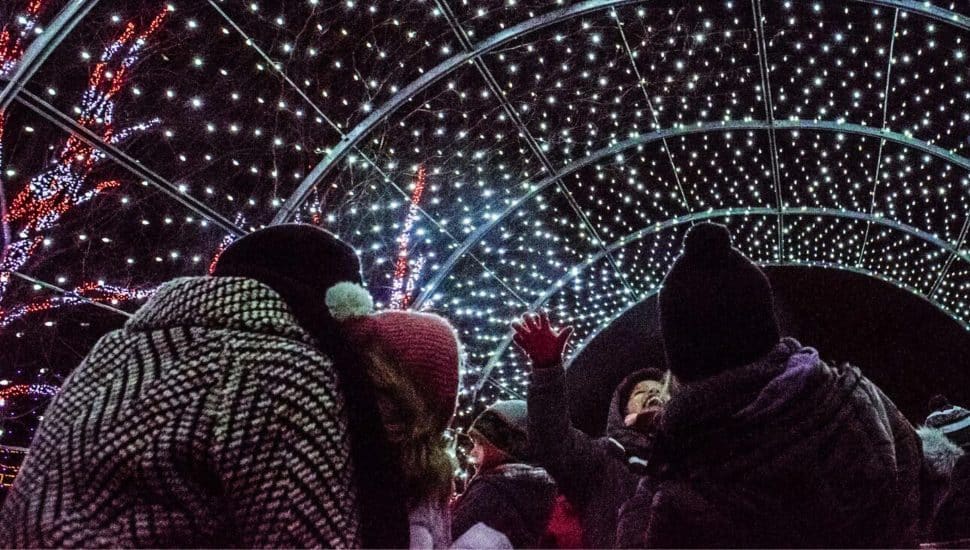 People walking through Shady Brook Farm's Holiday Light Show.