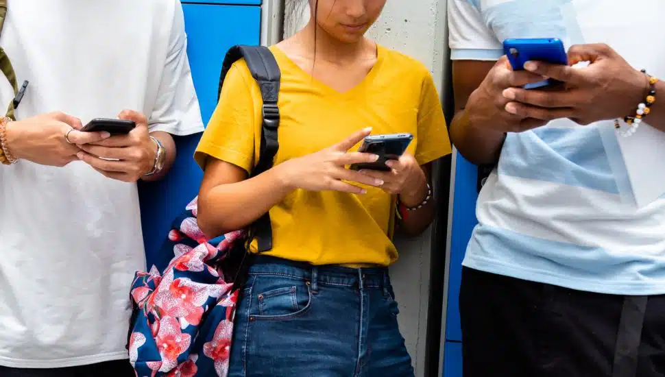 teen students using cellphones.