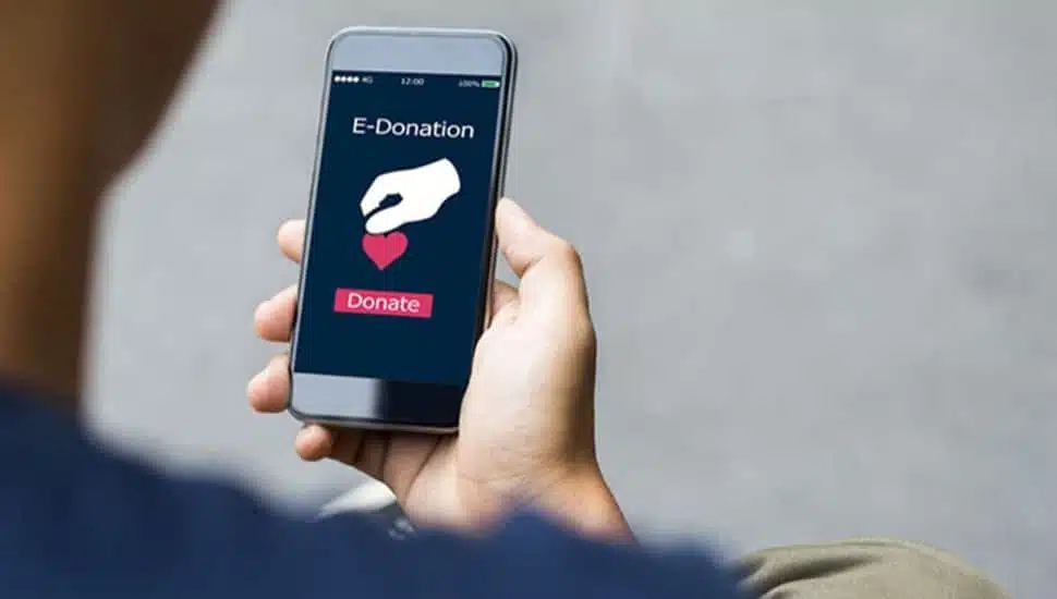 Person makes charitable donation on their mobile phone.