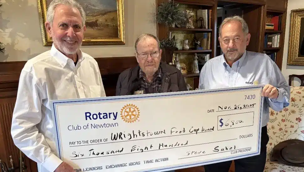 Gene Epstein and Paul Salvatore present check to Mitch McIntire.