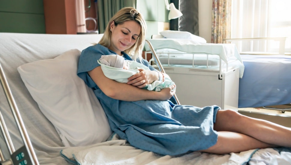 new mom holding baby.
