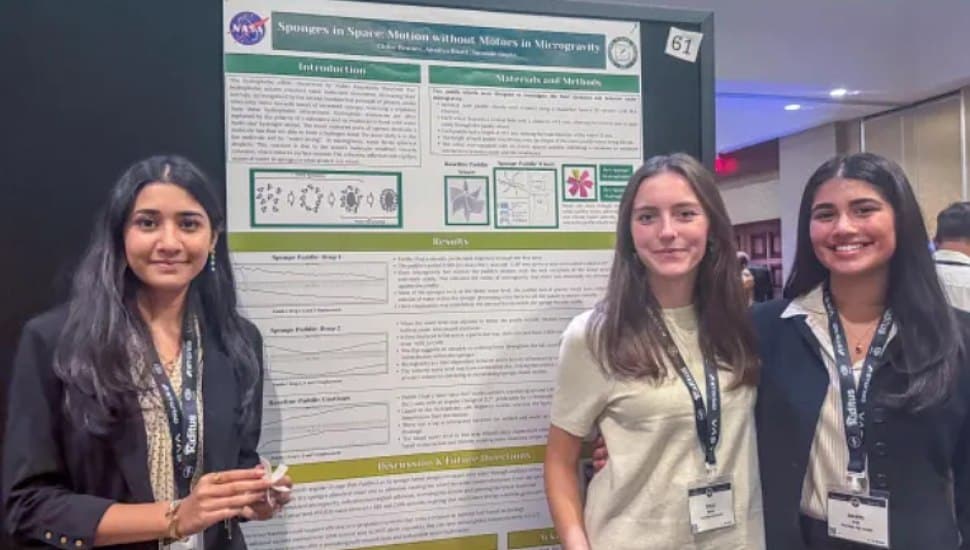 Chloe Benner, Ananya Bhatt, and Surabhi Gupta with their presentation board.