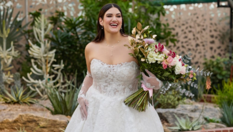 A woman showcases one of David's Bridal's new gowns.