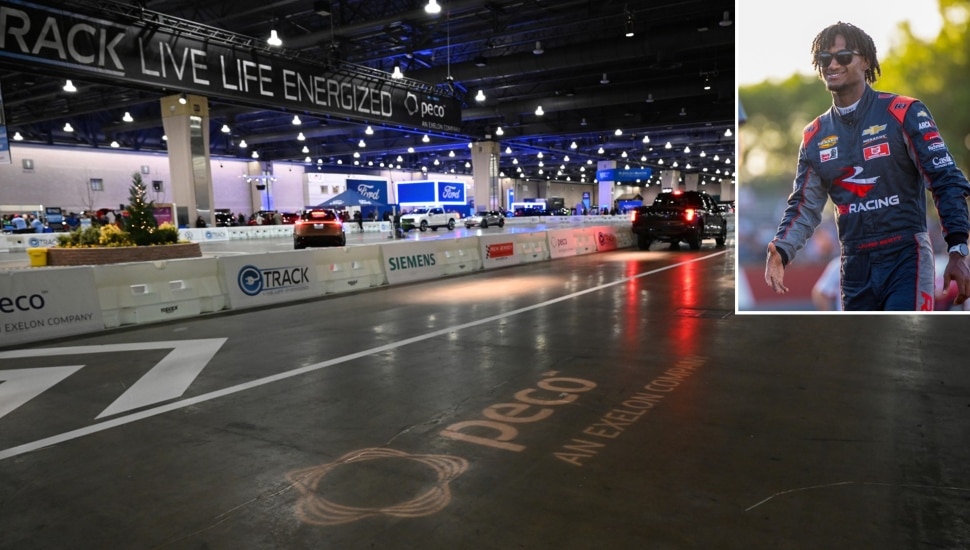 Vehicle test track at auto show with picture of NASCAR driver inset.