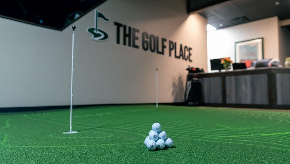 Golf balls on putting simulator at The Golf Place.