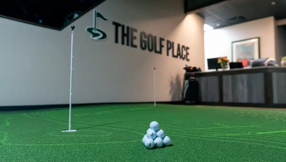 Golf balls on putting simulator at The Golf Place.