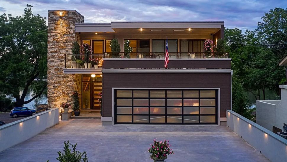 Modern home with stone accents and a garage.