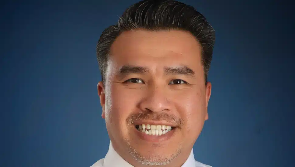 Middle-aged male banking executive in white shirt.