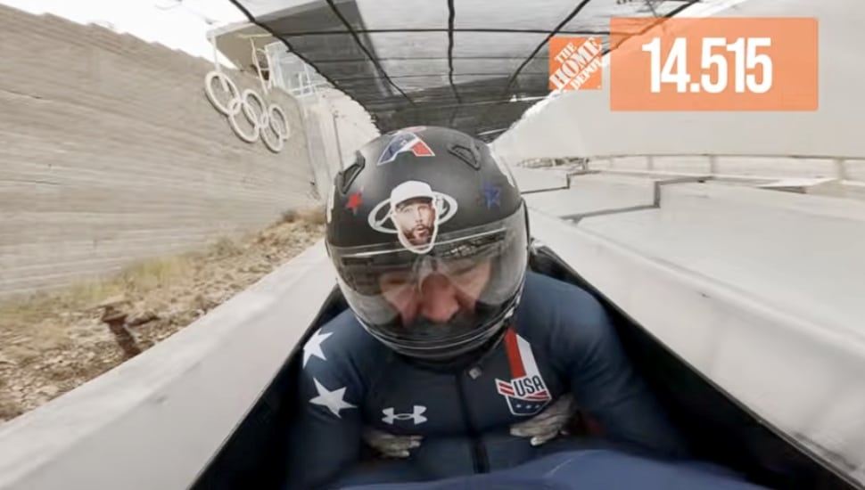 Jason Kelce with Team USA traveling down a bobsled track.