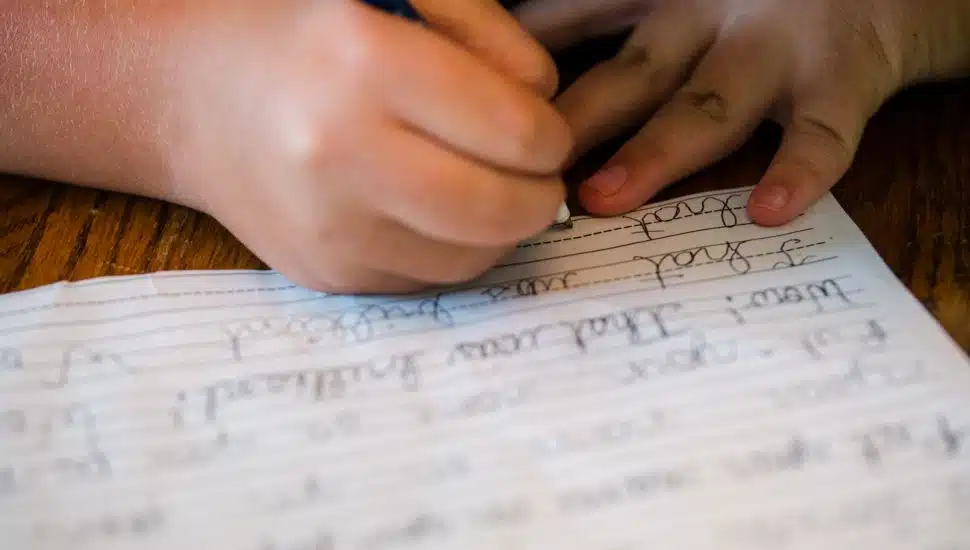 Kid writing cursive.