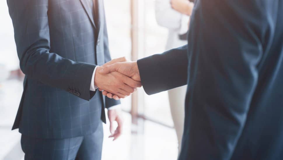 Business people shaking hands, finishing up a meeting.