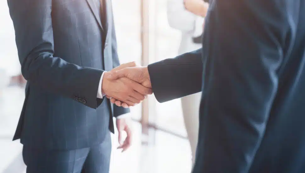 Business people shaking hands, finishing up a meeting.