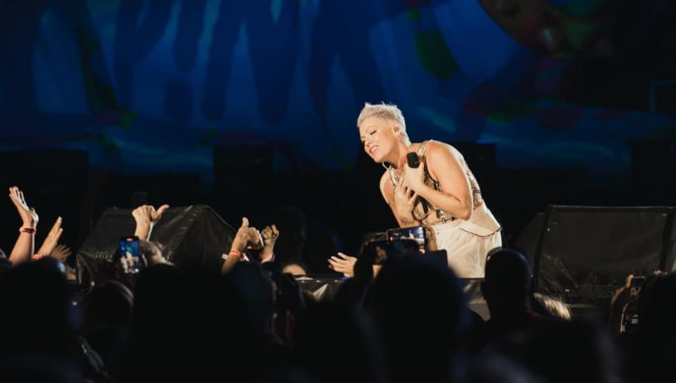 Pink singing to audience of fans.