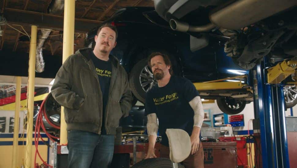 Shane Gillis (left) and Chris O'Connor in Tires garage.