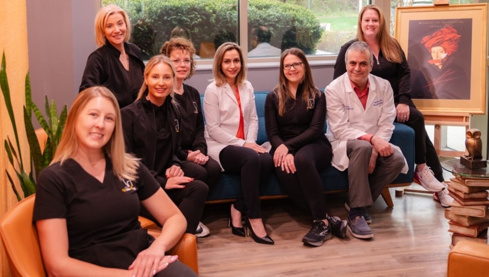 Dental professionals pose for group photo.