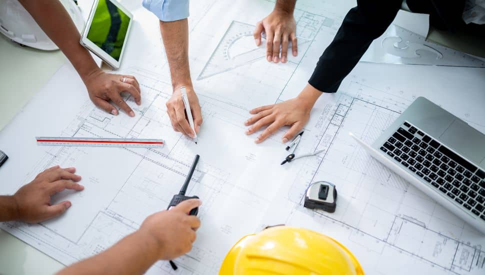Group of engineers discussing plans.