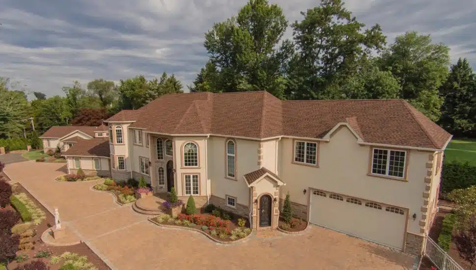 Large two-story home with a garage and driveway.