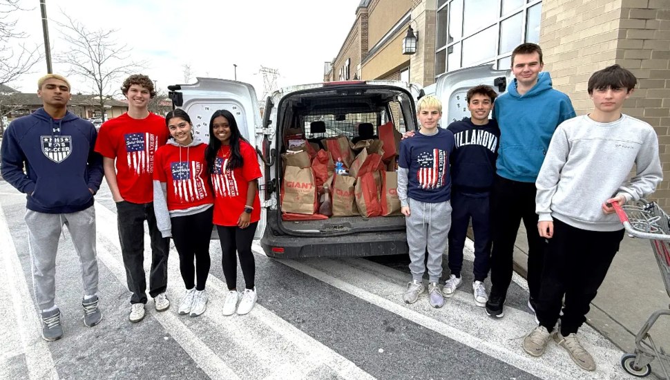 Students with donations in a car.