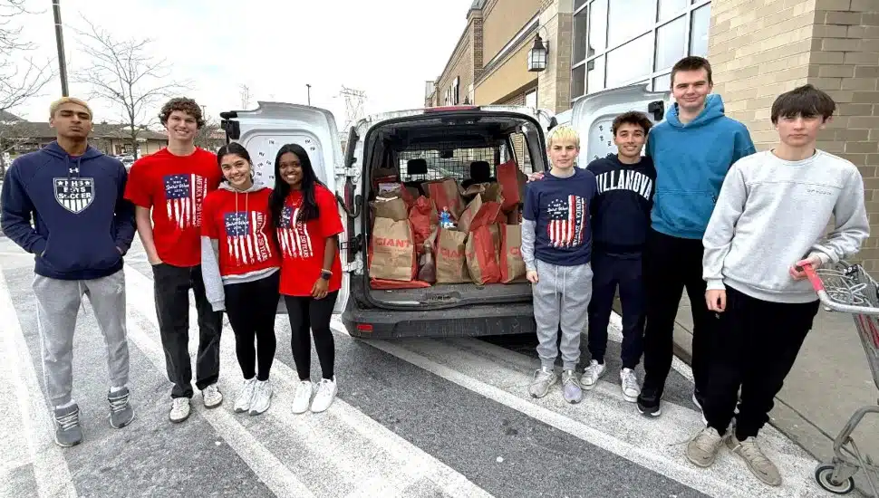 Students with donations in a car.